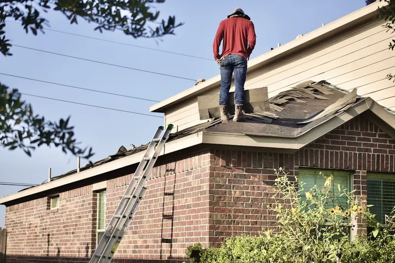 Professional roofer working on a residential roof in Battle Ground West